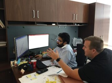 Engineers examining computer results on the monitor