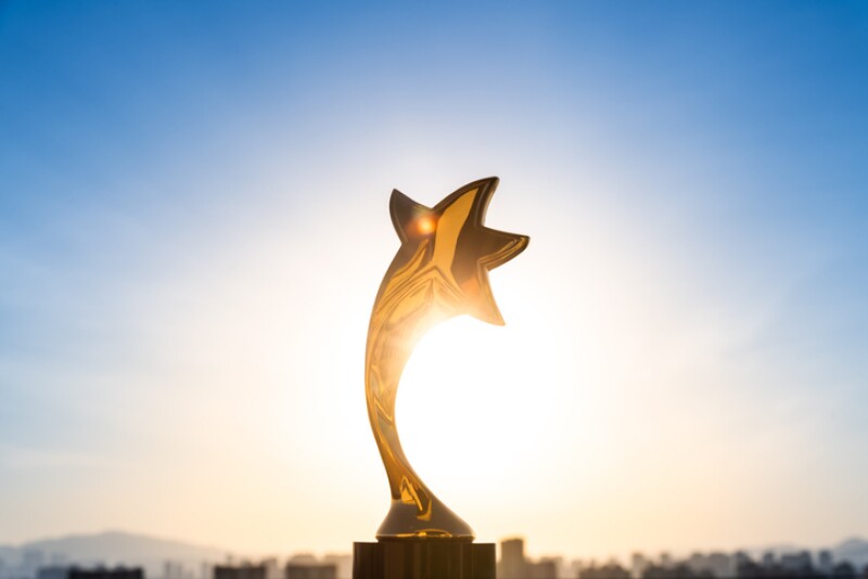 Gold star on a clear sky background as a reward