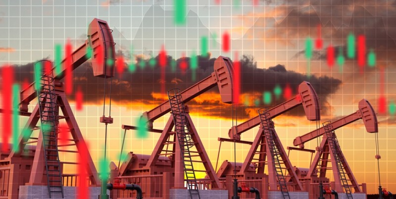 Oil pumpjacks against the sunset with financial graphs