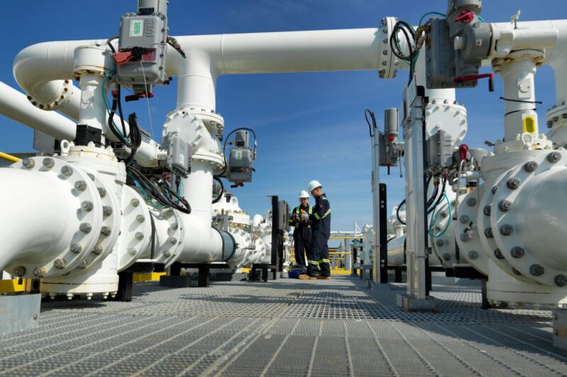 Workers examining a pipeline in Cushing, Oklahoma