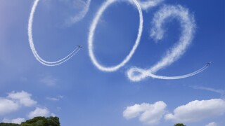 CO2 written in airstreams over a rural scene