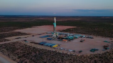Drone view captures a stunning sunset over the Permian Basin, where a fracking drilling oil rig stands tall, symbolizing the intersection of nature and industry