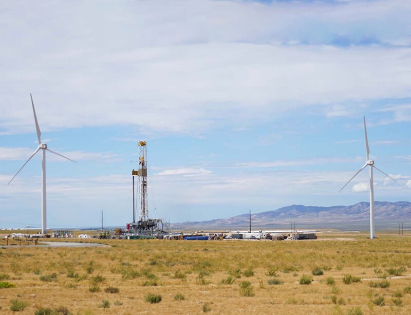 Fervo Energy drills wells for its Cape Station project at the US Department of Energy’s Frontier Observatory for Research in Geothermal Energy (FORGE) research site where turbines in the background are a reminder of the competition it will face from other alternative energy sources. Source: Fervo Energy.