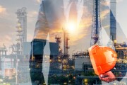 Double exposure of businessman or engineer hole orange helmet in hand with oil and gas refinery plant background