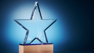 crystal star shape trophy against blue background
