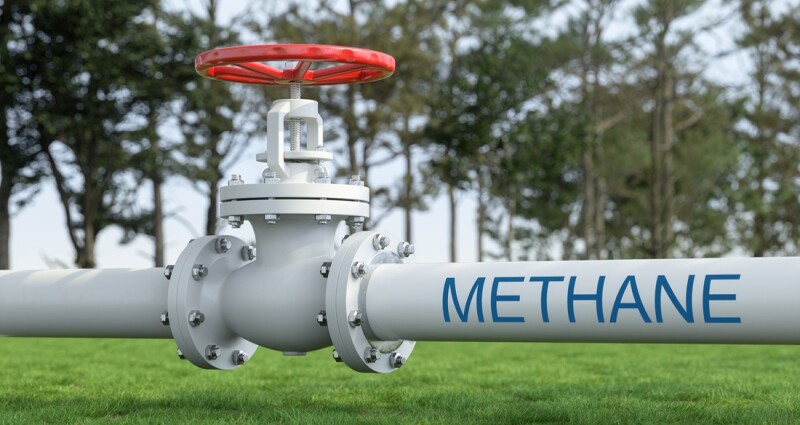 White Industrial Pipelines Transporting Methane Gas Across Green Field. Energy Infrastructure Concept