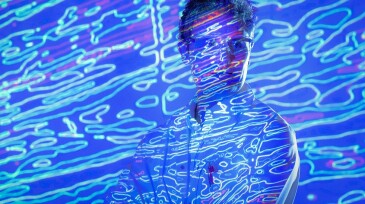 Portrait of male scientist with graphical geological data projection