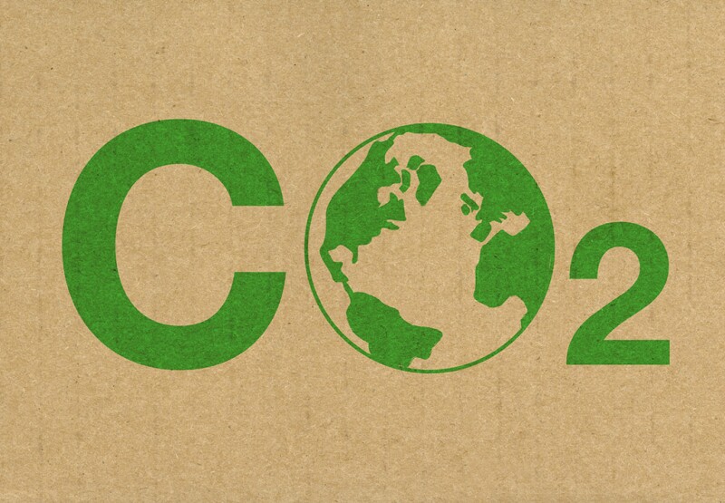 A green CO2 logo on a brown cardboard background