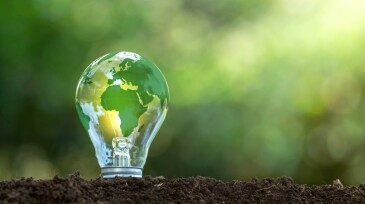 Renewable Energy.Environmental protection, renewable, sustainable energy sources. The green world map is on a light bulb that represents green energy Renewable energy that is important to the world