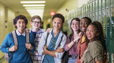Multi-ethnic high school students hanging out in hallway