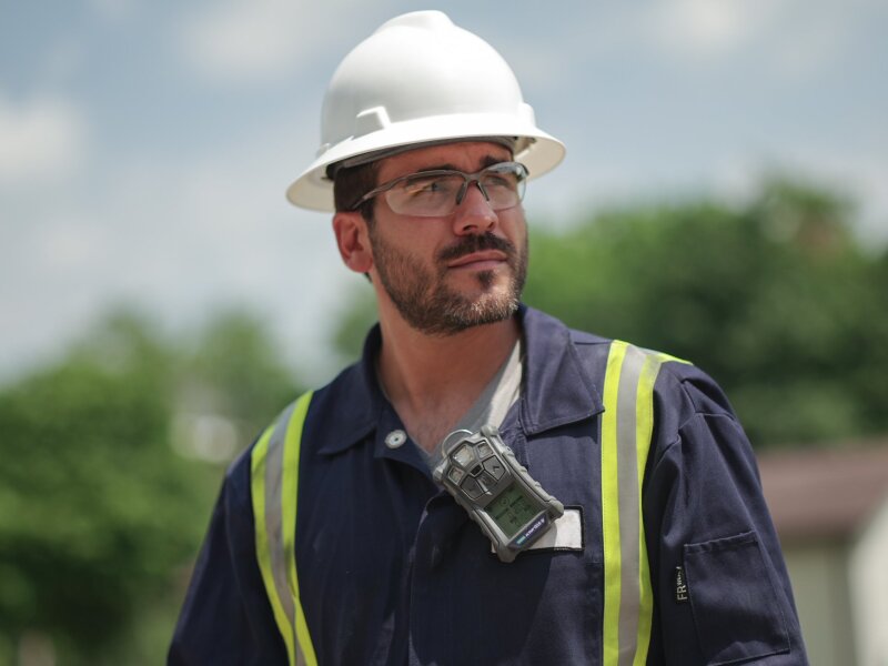 Worker wearing personal digital safety device.