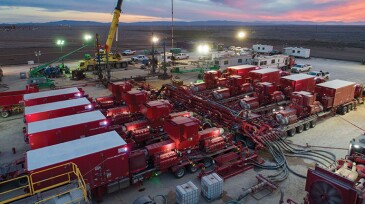 Red containers at station in large field