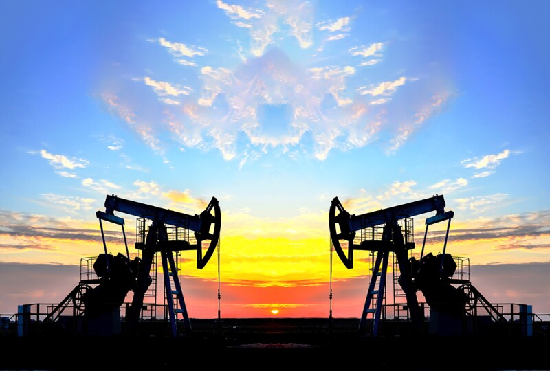 Oil drilling derricks at desert oilfield for fossil fuels output and crude oil production from the ground.