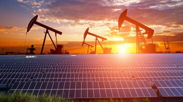 Oil pump with solar panels and the sunset