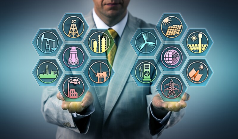 Manager balancing out fossil fuels and renewable energy resources in the palm of his hands.