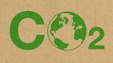 A green CO2 logo on a brown cardboard background