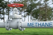 White Industrial Pipelines Transporting Methane Gas Across Green Field. Energy Infrastructure Concept
