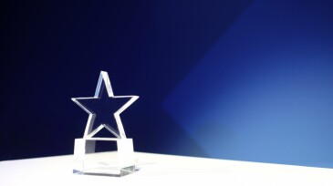 Award on a table with spotlights and copy space