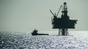 Silhouette of an Offshore Supply Vessel alongside oil platform Ringhorn in the North Sea