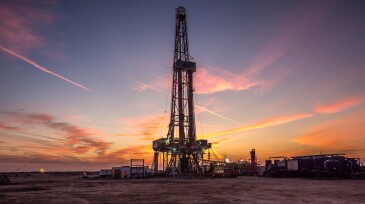 Oil drilling platform at sunset