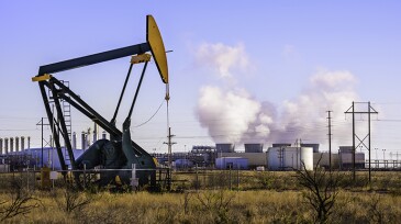 A pumpjack (oil derrick) and oil refinery in Seminole, West Texas.