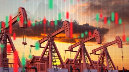 Oil pumpjacks against the sunset with financial graphs