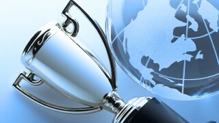 Close-up of silver trophy next to globe focusing on North America.