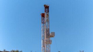 Dual drilling rigs rise above the landscape of the Vaca Muerta Shale in Argentina. Source: Getty Images.