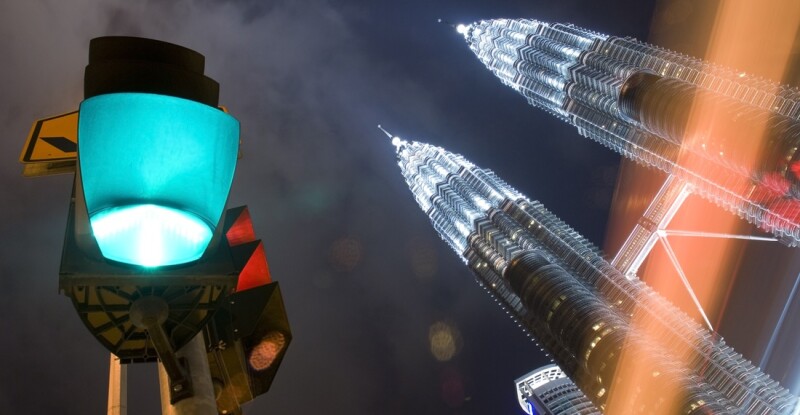 Kuala Lumpur at night with green light and Petronas Towers