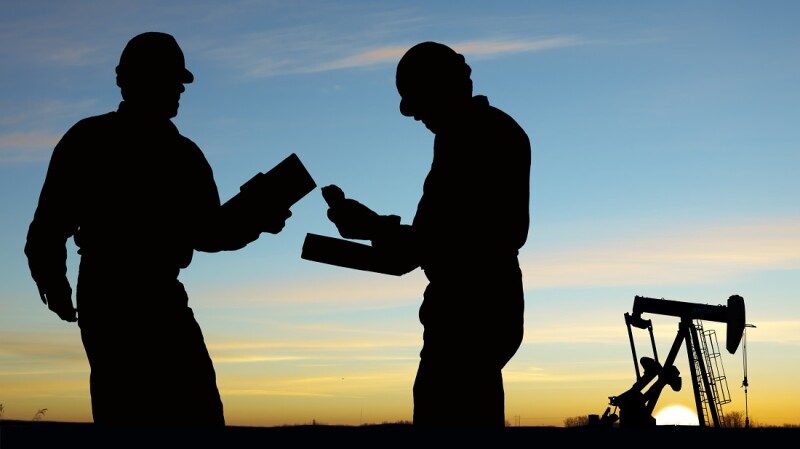 2 silhouettes of oil workers and a pump