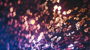 Abstract of lighted, colorful numbers on a black background