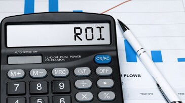 Word ROI on calculator. Business and tax concept. Stock photo