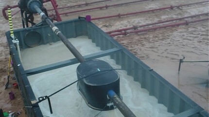 livestock trough is buckled down over a section of pipe perforated as a cluster within a fracturing stage
