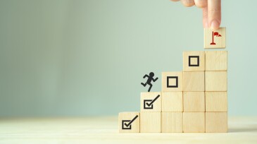 Work in progress concept. Goals, targets, tasks tracking. Goals achievement and business success.  Task completion. Managing project timeline. Wooden blocks with target achievement icon.