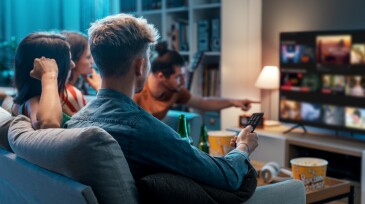 Friends watching movies together at home