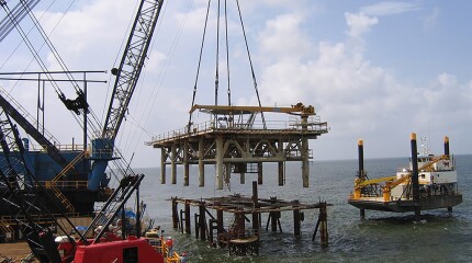 The topsides are lifted up from a platform being decommissioned in the Gulf of Mexico.