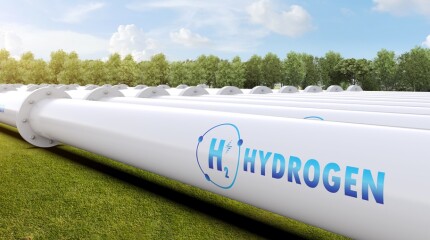 Metal pipeline with green field and blue sky background