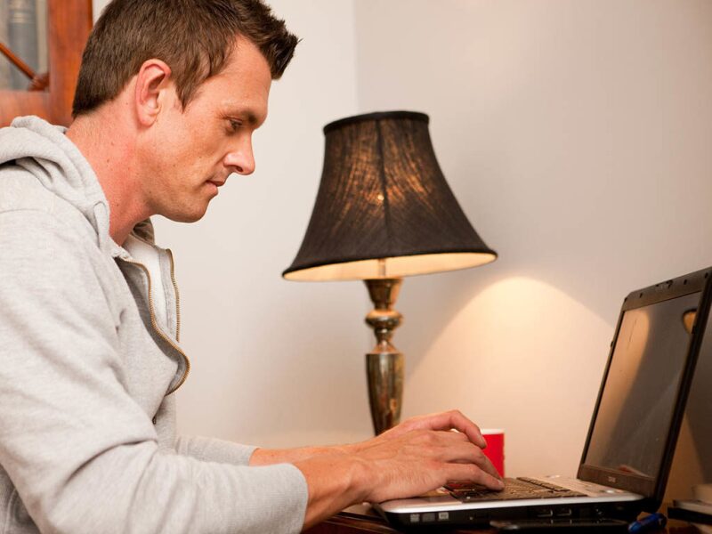 man working at his home computer