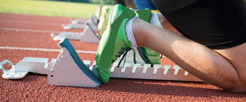 Feet on starting block ready for a spring start.