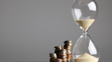 Hour glass with stacked coins