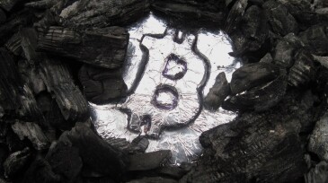 Bitcoin mining. A mine with real hardware. Symbols of block chain technology for crypto currency  metal coin, coal, pickaxe