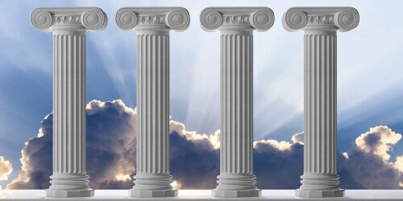 Four pillars with clouds and sun beams behind them