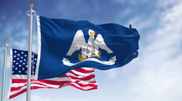 The Louisiana state flag waving along with the national flag of the United States of America