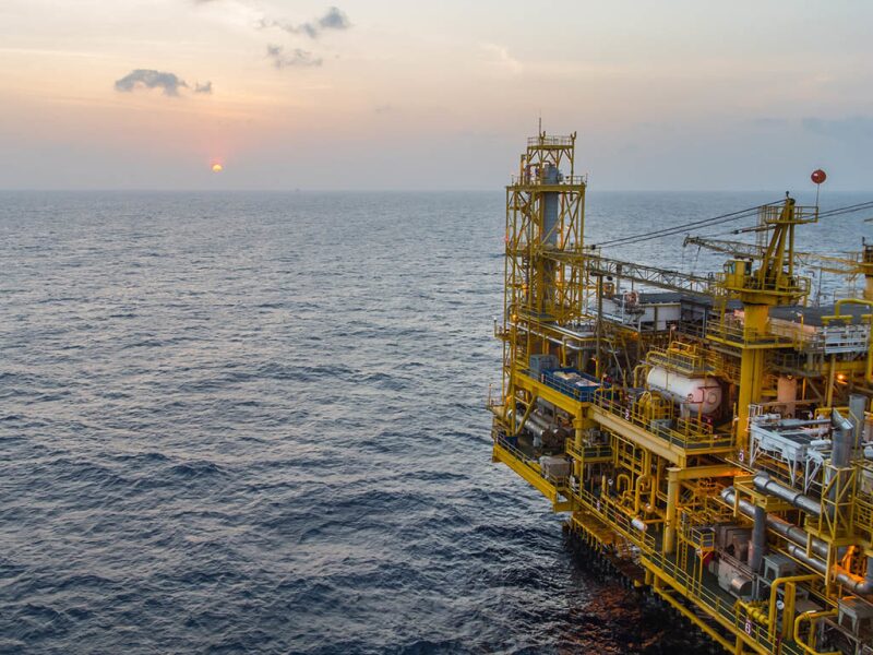 partial view of platform on ocean at sunset