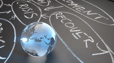 Debt crisis recovery flowchart on a chalkboard with globe showing Europe